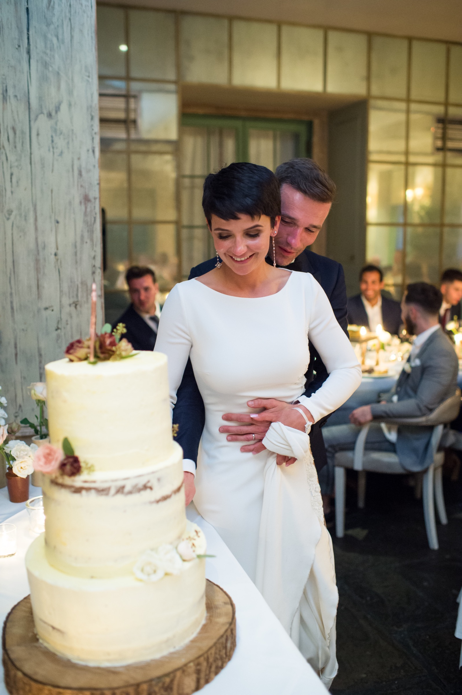 a newly married couple cutting the wedding cake at babington house